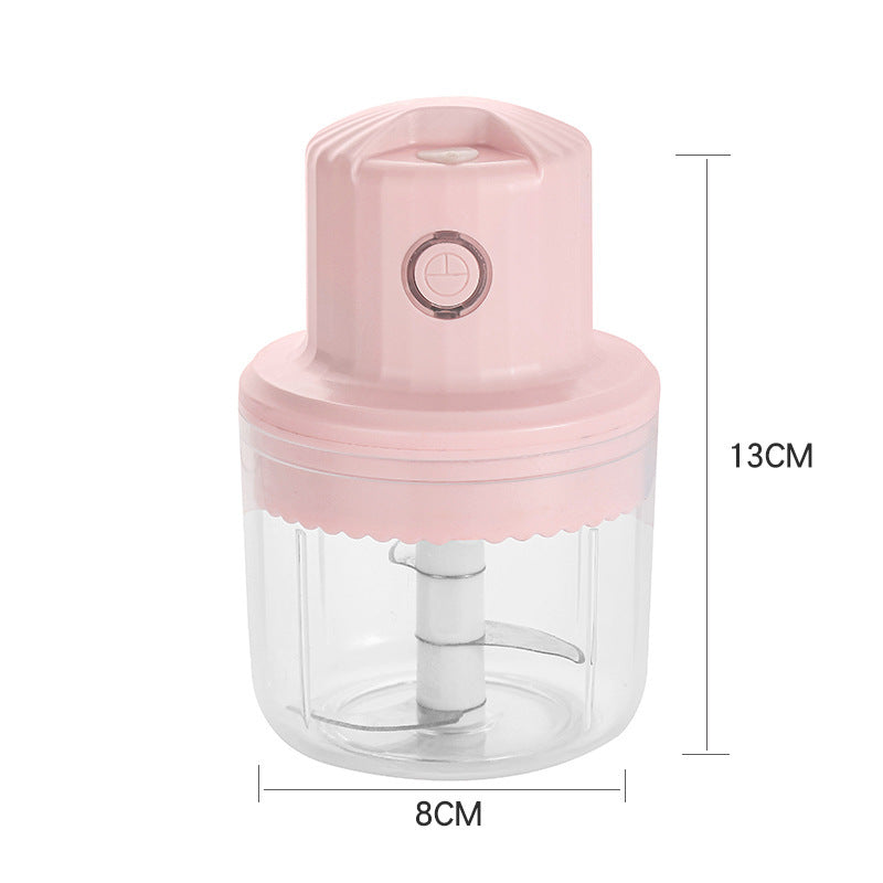 Pink hand juicer with clear container and measurements on a white background