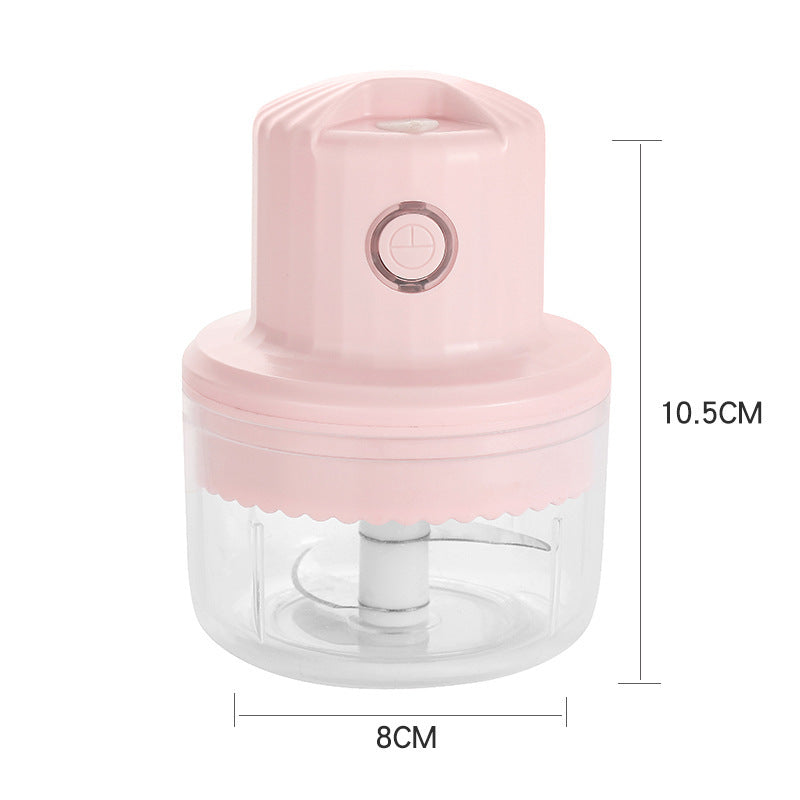 Pink handheld chopper with clear container and measurements on a white background