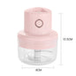 Pink handheld chopper with clear container and measurements on a white background
