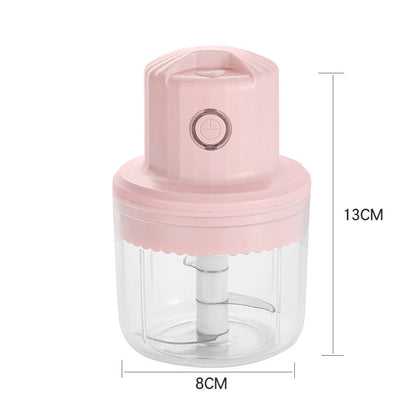 Pink hand juicer with clear container and measurements on a white background