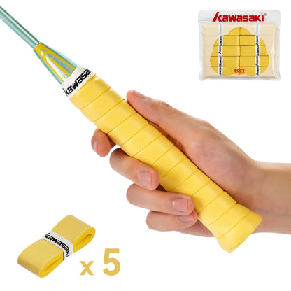 Hand holding a yellow badminton racket grip with Kawasaki branding, and a small package of grips in the corner.