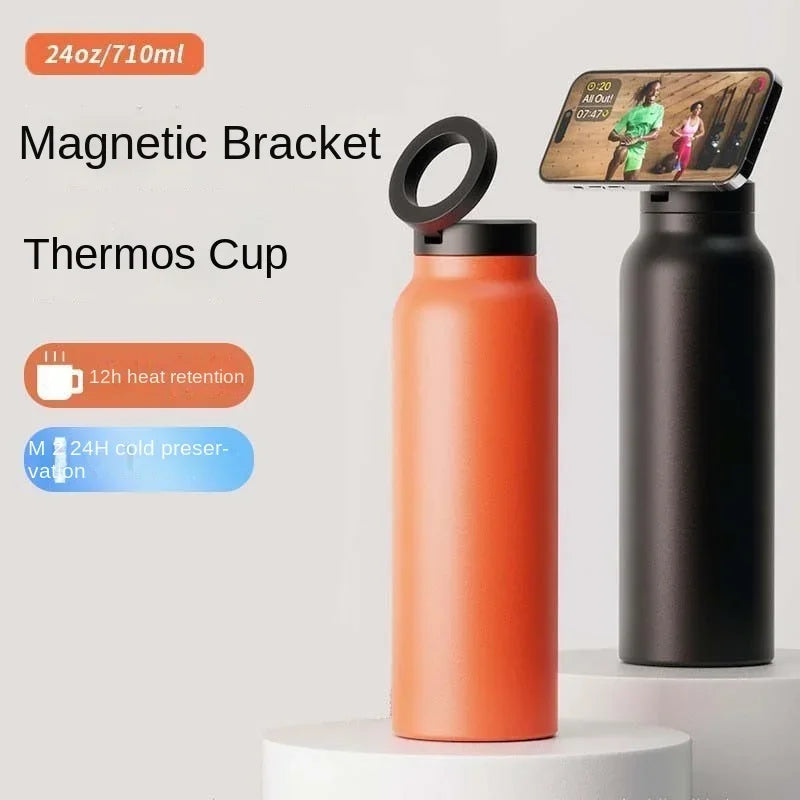 Orange thermos cup with black magnetic bracket and smartphone holder on a light gray background
