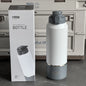 TYESO vacuum insulated bottle with packaging in front of a refrigerator.