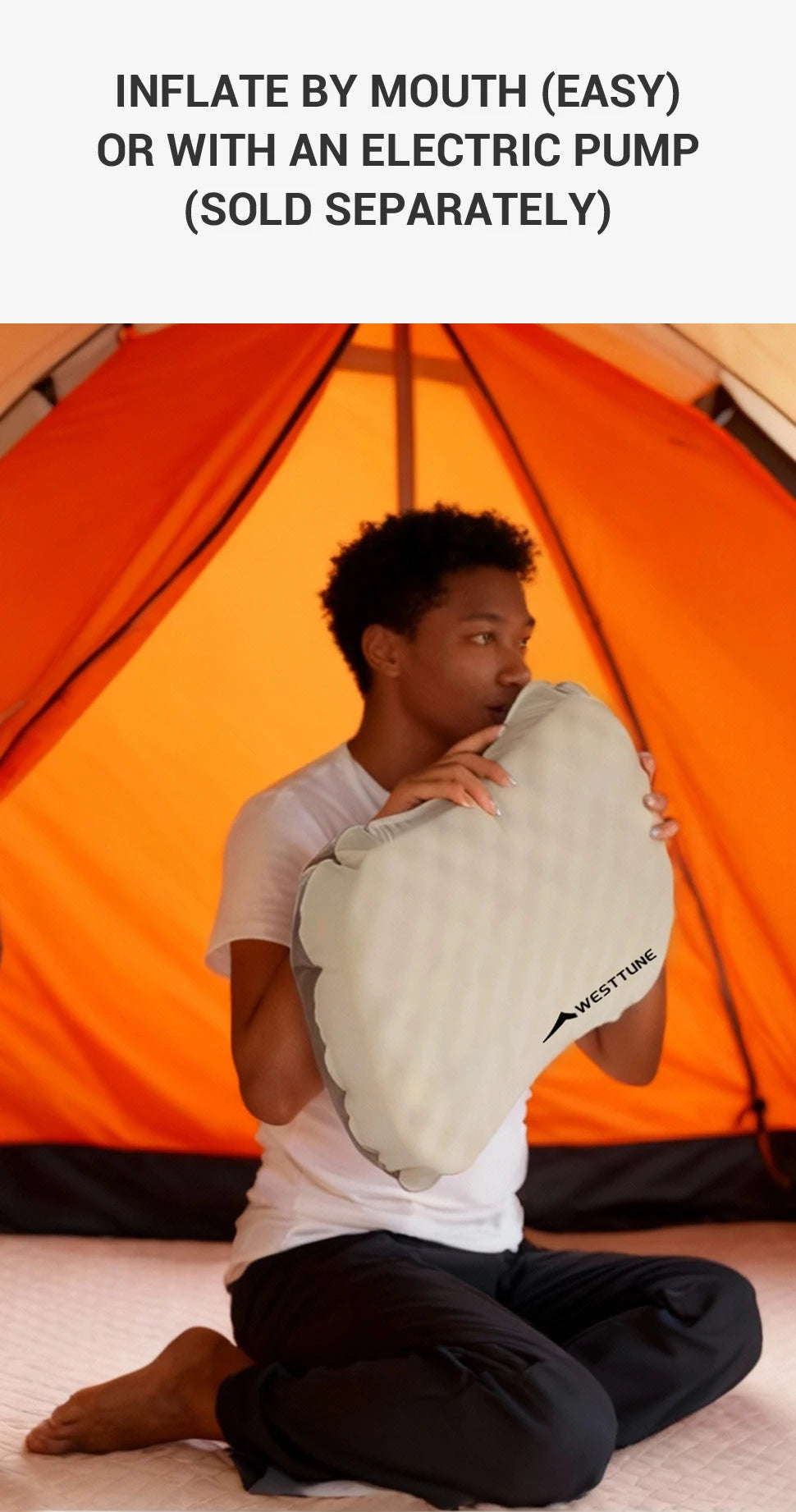 Person holding an inflatable pillow with text about inflation methods in front of an orange tent.
