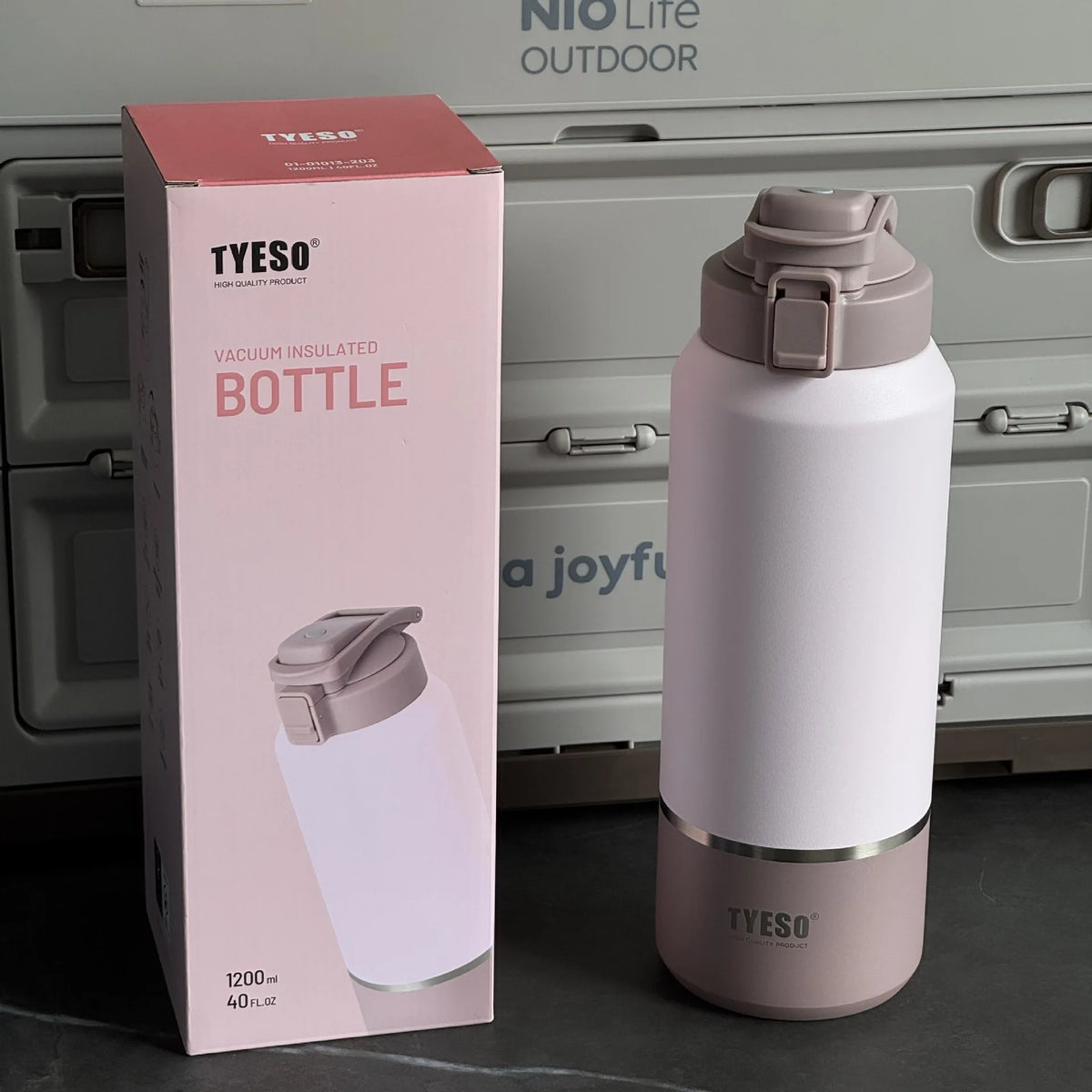 TYESO vacuum insulated bottle with packaging in front of a cooler