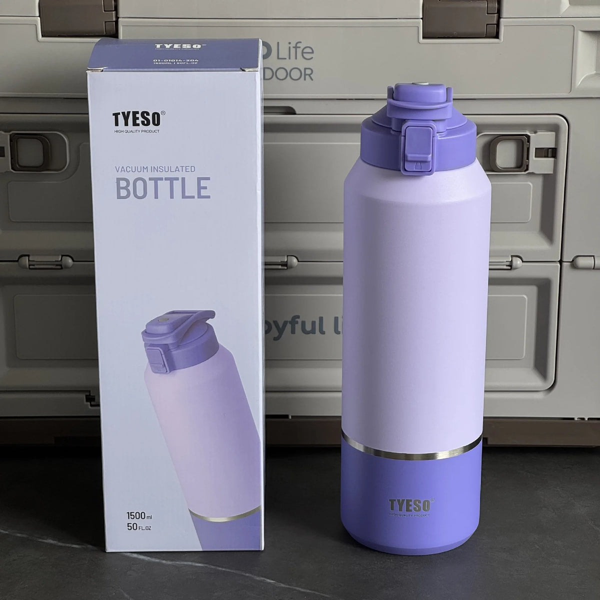Purple insulated bottle with packaging and cooler in the background