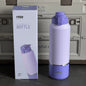 Purple insulated bottle with packaging and cooler in the background