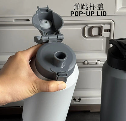 Hand holding a pop-up lid for a container with text indicating 'POP-UP LID'.