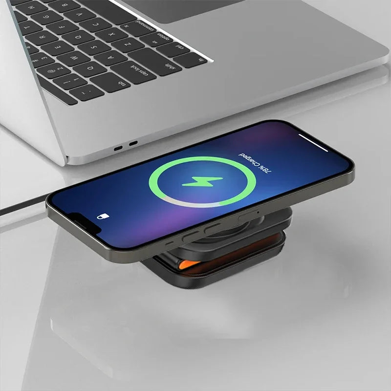 Phone on a wireless charging pad with a laptop in the background