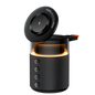 Black portable speaker with a glowing interior on a white background