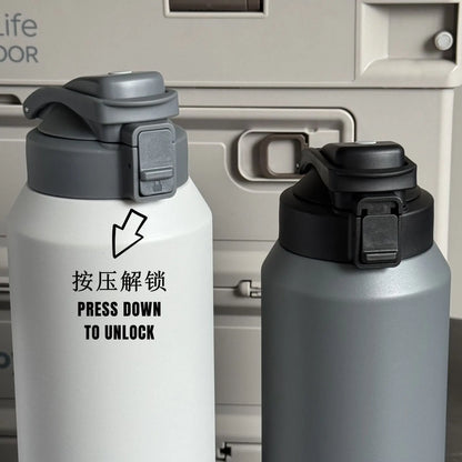 Two insulated water bottles with black and gray lids on a metallic background.