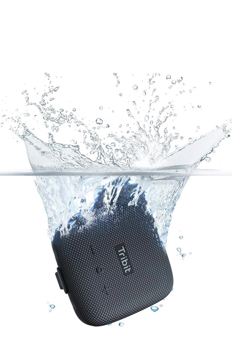 Black portable speaker with 'TREV' branding being splashed by water on a white background