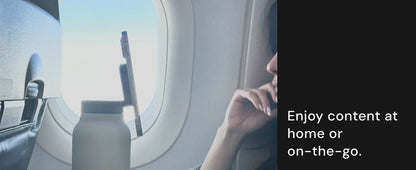 Person on an airplane looking out the window with a water bottle in hand, text 'Enjoy content at home or on-the-go'.