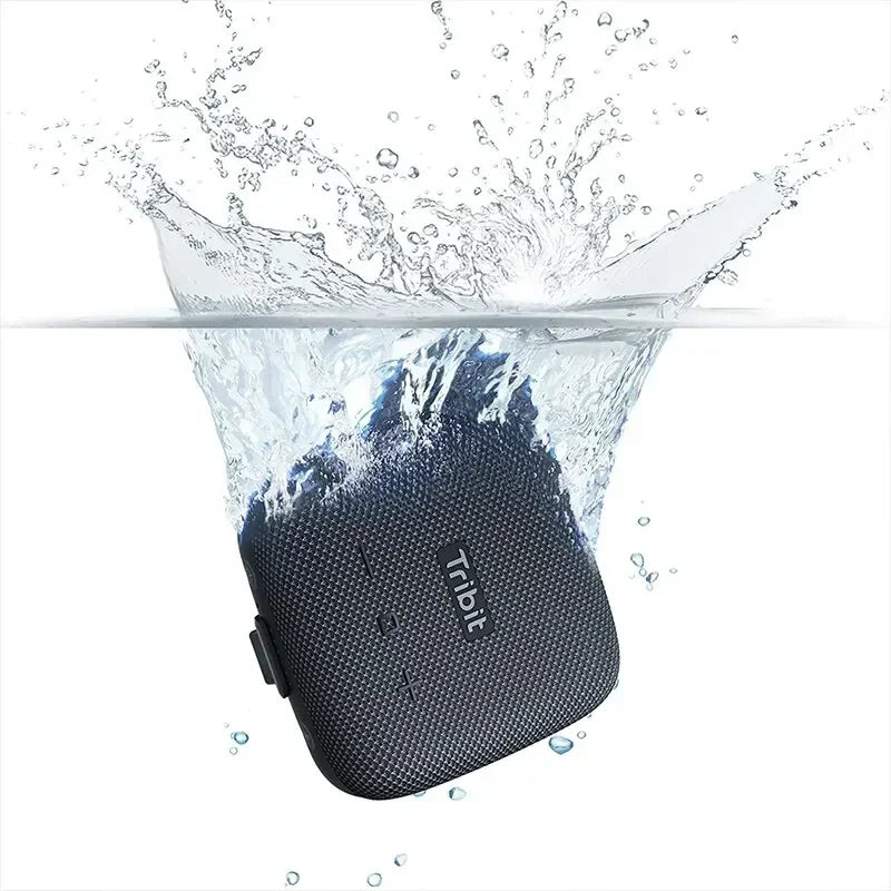 Black portable speaker being submerged in water with 'Troll' branding.