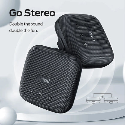 Black Tribit stereo speakers with 'Go Stereo' text on a light gray background