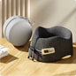 Gray travel neck pillow on a wooden surface with a beige background