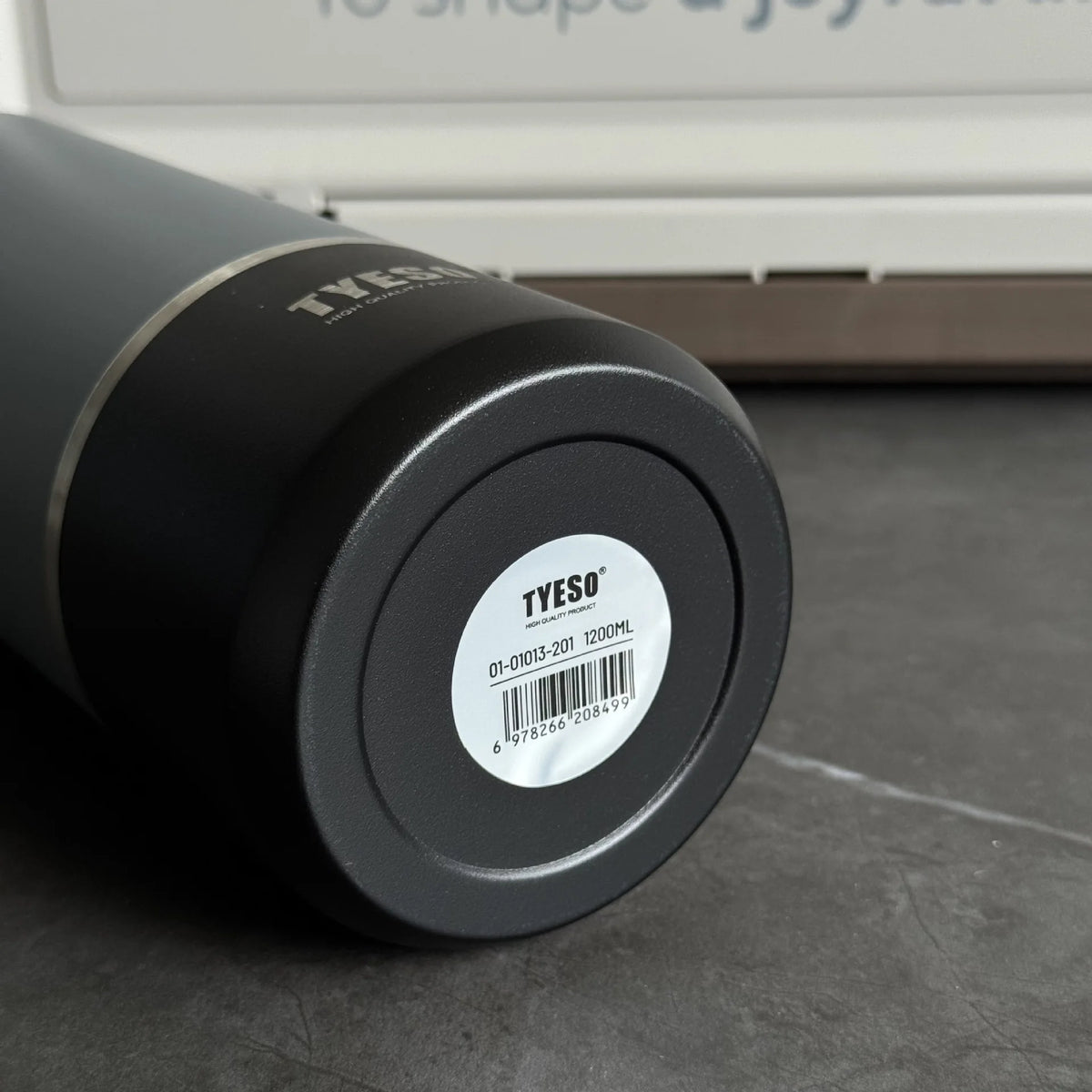 Black tumbler with 'TYESO' branding on a gray surface
