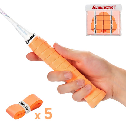 Hand holding an orange tennis racket grip with Kawasaki packaging and additional grips on a white background